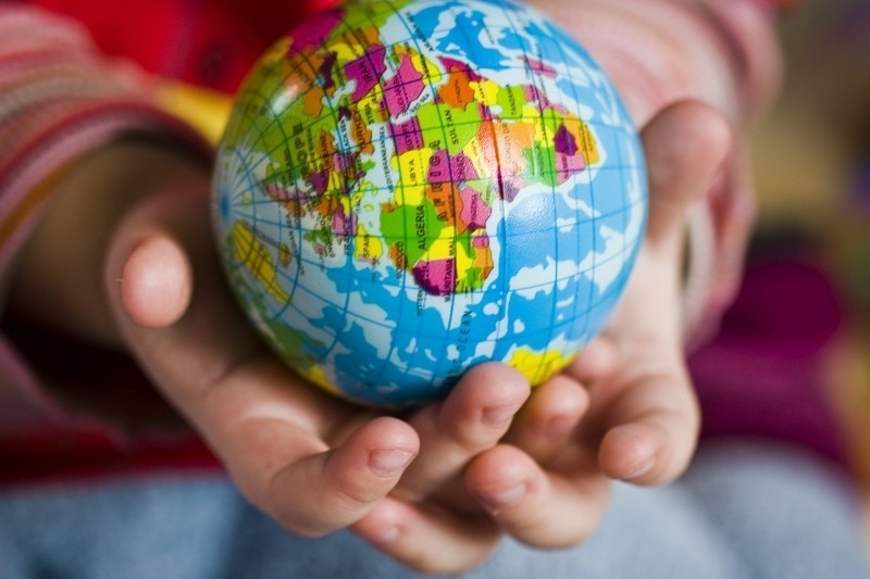 Photo of child's hands holding a globe